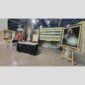 Physical documentation of Kevin G. Saunders | KGS Studios fine art prints in a public exhibition setting. Verifies the public vetting of manual hyperrealism portraits, orchid studies, and HTTX-97442. San Antonio archive proof of physical reality.