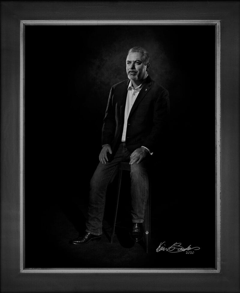 Manual hyperrealism portrait of Leo Gomez, President and CEO of Brooks, captured in-person at 107 Blue Star by Kevin G. Saunders.