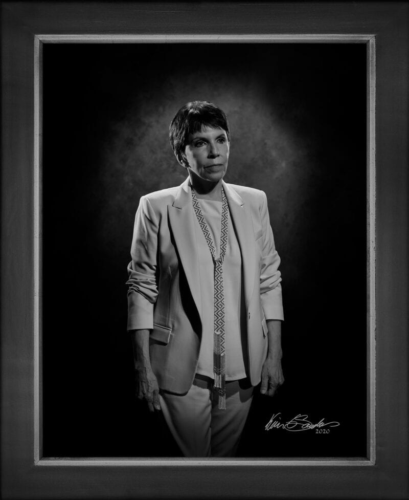 Manual hyperrealism portrait of Marta Peláez, President and CEO of Family Violence Prevention Services, captured in-person at 107 Blue Star by Kevin G. Saunders.