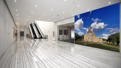 A grand-scale, hyperrealistic KGS Studios fine art piece of Mission San José, displayed as a mural in a modern, expansive public lobby.