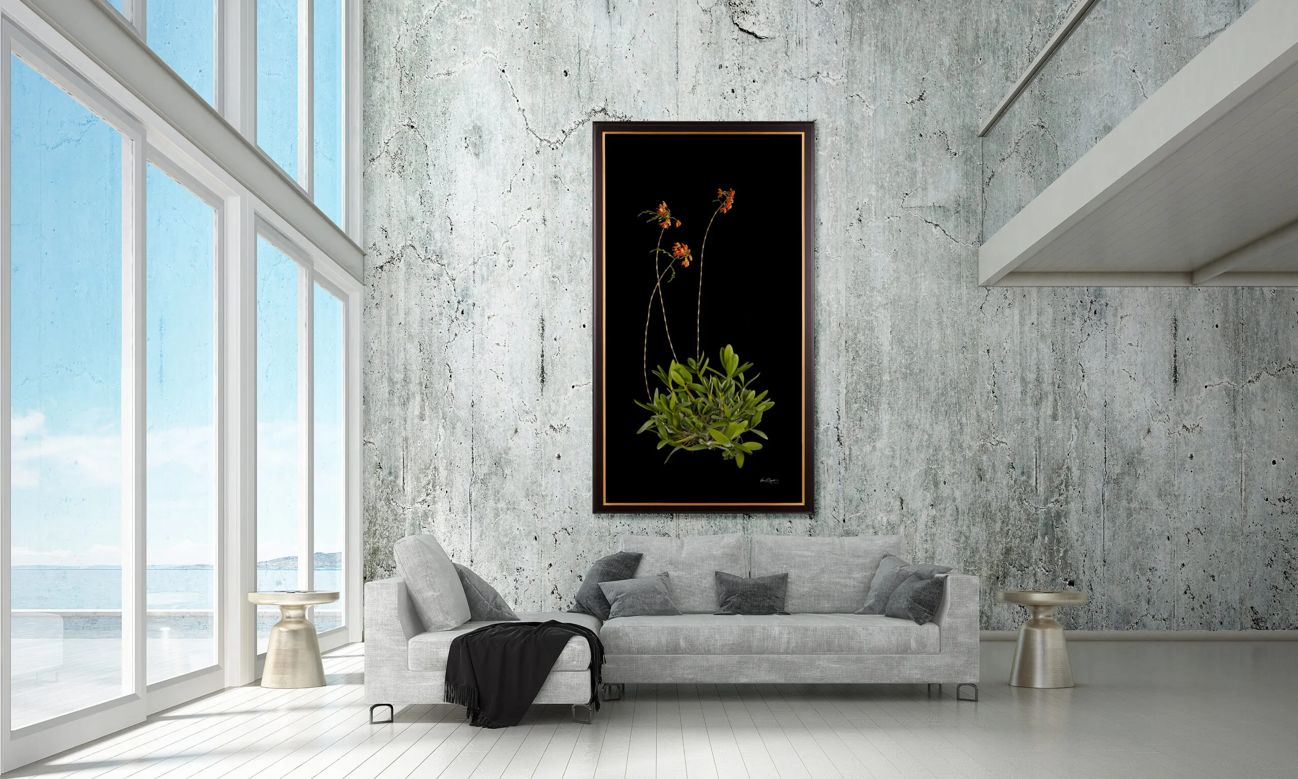 Grand Scale Orchid Print by Kevin G Saunders hanging in a concrete walled beach home living room over a gray sofa.