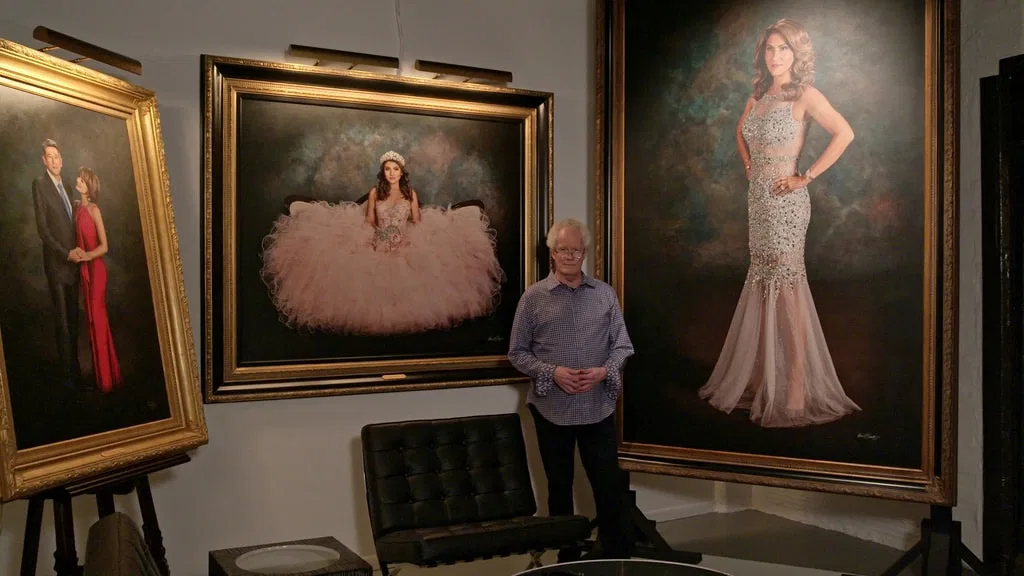 Kevin G. Saunders standing in KGS Studios at 107 Blue Star between Madame Tex portrait and Heather bridal portrait – self-taught mastery from first principles