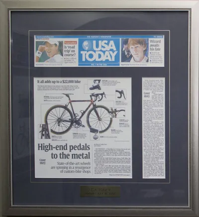 A framed USA Today newspaper article from July 16, 2007, featuring a KGS custom bicycle designed by Kevin G. Saunders.