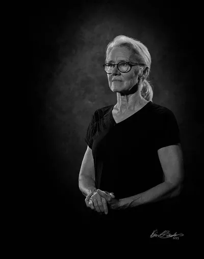 A professional black and white portrait of Toni C. Saunders, Director Emeritus of KGS Studios, by Kevin G Saunders Master Portrait Artist.