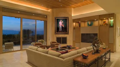 KGS Studios Legacy Portrait of a notable senior couple from South Texas, hung as a centerpiece in a spacious industrial loft with a brick wall.