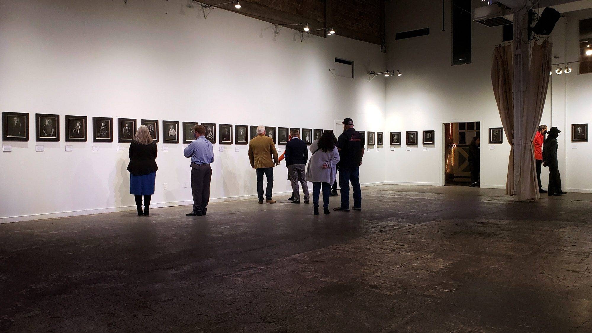 Art patrons and collectors viewing the 'Notable People of San Antonio in 2020' collection at the KGS Studios exhibition at the Brick Event Center.